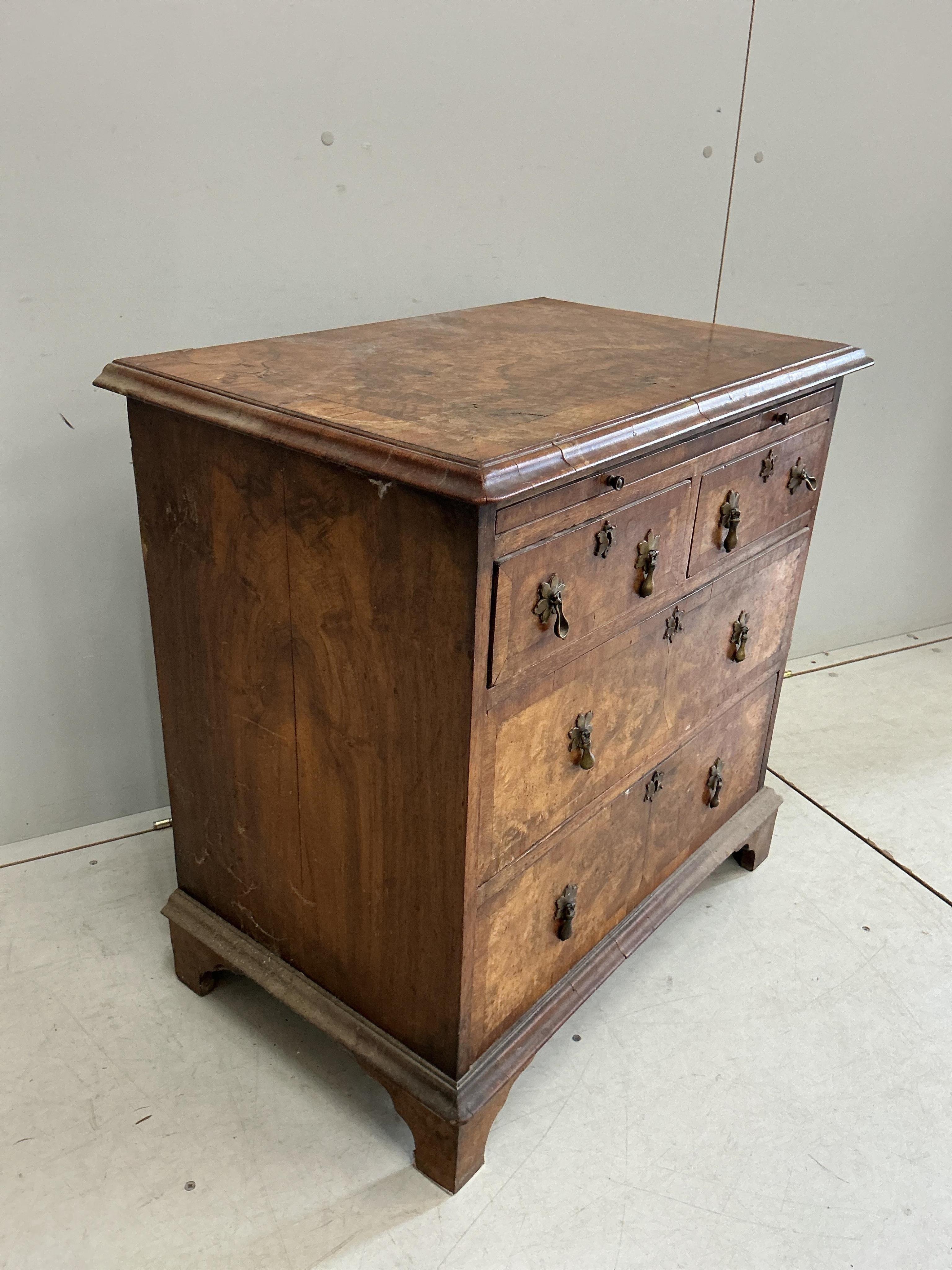A small Queen Anne Revival crossbanded walnut bachelor’s chest with slide, width 71cm, depth 45cm, height 72cm